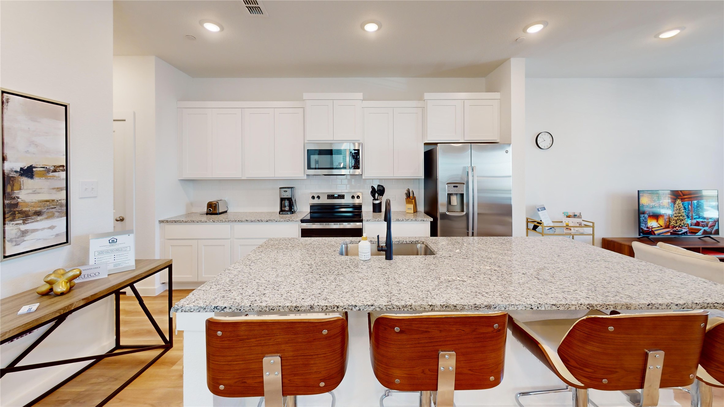 2906 ELLE Drive Grand Prairie, TX 75052 - Photo 19 of 47 a kitchen with stainless steel appliances granite countertop a table chairs in it and white cabinets