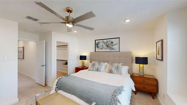 a bedroom with a bed and a painting on the wall