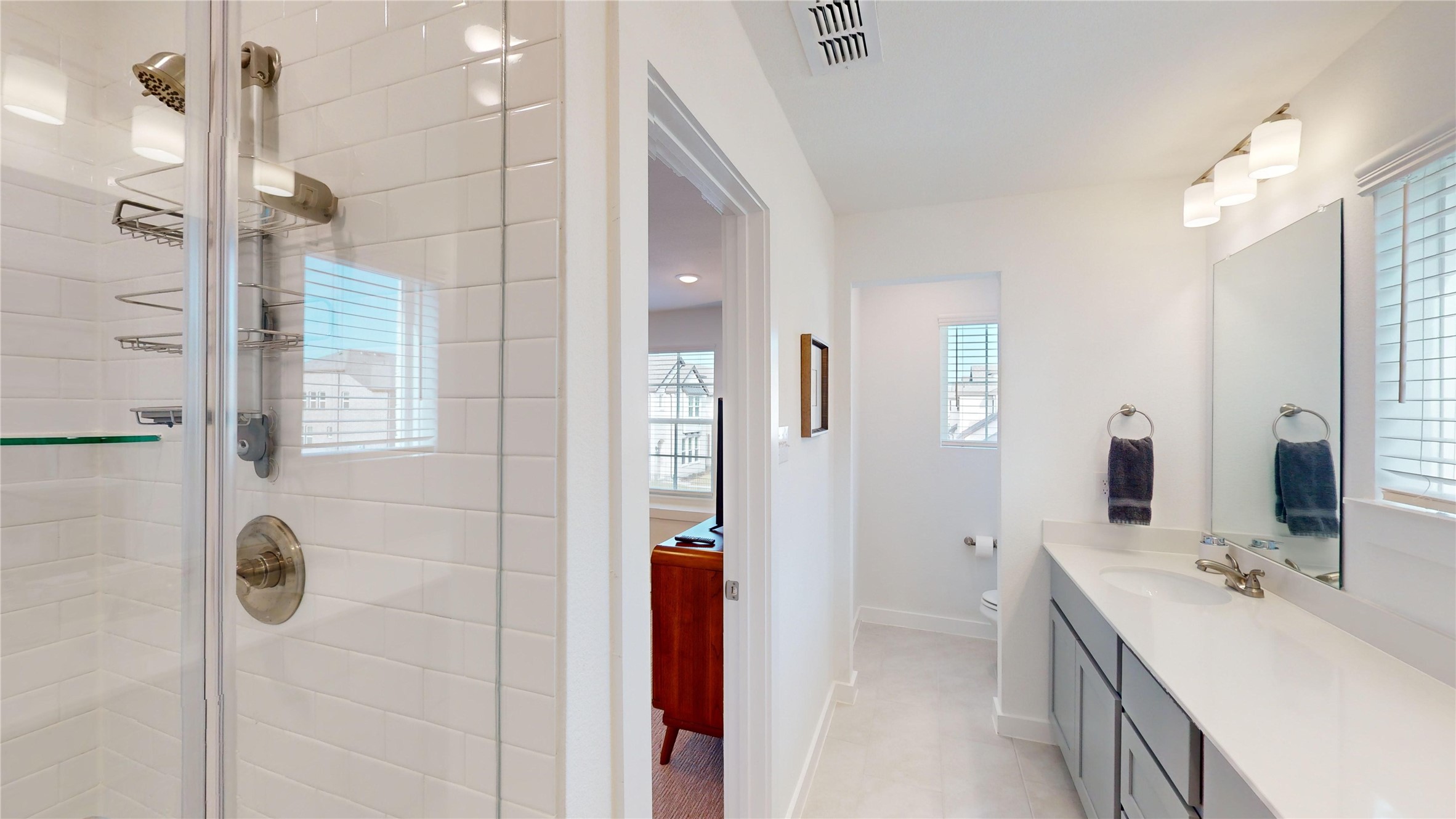 2906 ELLE Drive Grand Prairie, TX 75052 - Photo 31 of 47 a bathroom with a double vanity sink a mirror and shower
