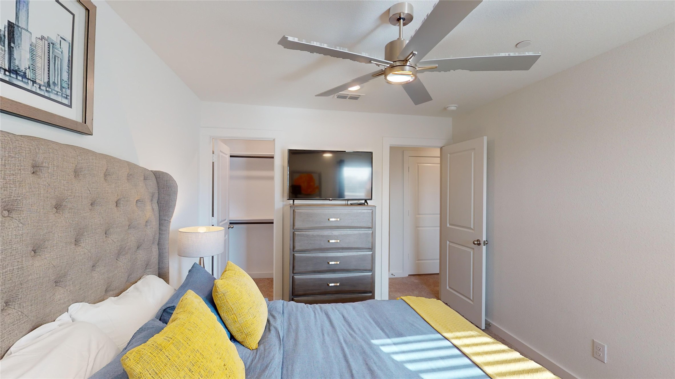 2906 ELLE Drive Grand Prairie, TX 75052 - Photo 35 of 47 a bedroom with a bed and a flat screen tv