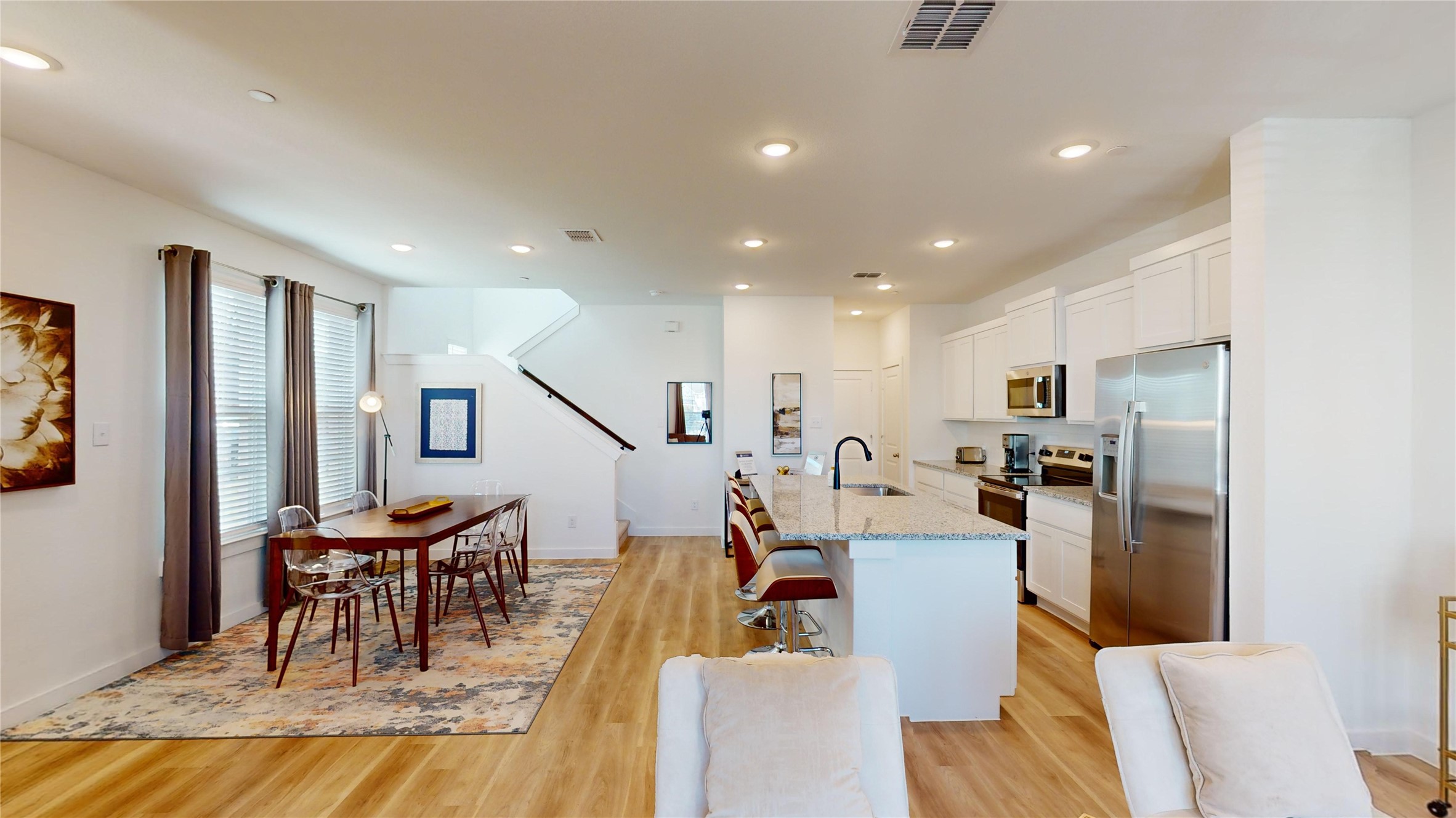 2906 ELLE Drive Grand Prairie, TX 75052 - Photo 8 of 47 a living room with furniture a kitchen view and a refrigerator