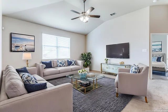 a living room with furniture and a flat screen tv
