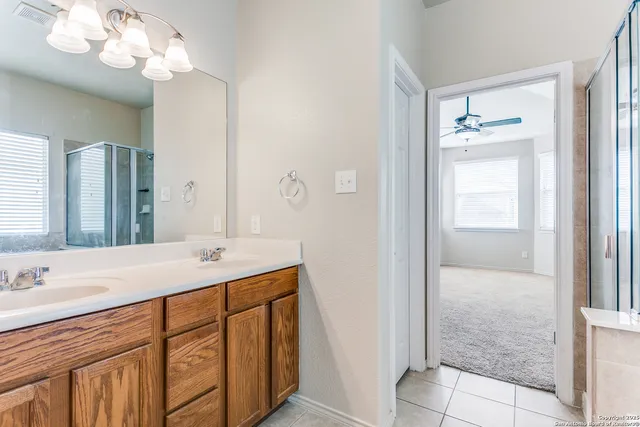 a bathroom with a sink vanity and a mirror