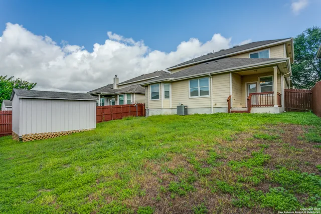a front view of a house with a garden and yard