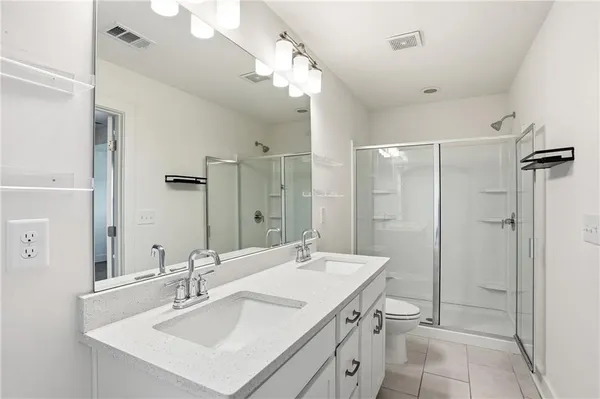 a bathroom with a sink a toilet a mirror and bathtub