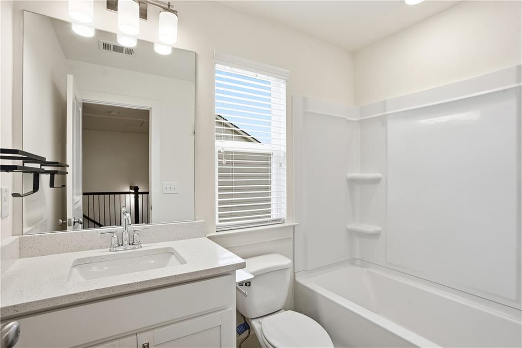 6360 Princeton Ridge Drive, Unit 6360 Lithonia, GA 30058 - Photo 13 of 16 a bathroom with a granite countertop sink toilet and shower