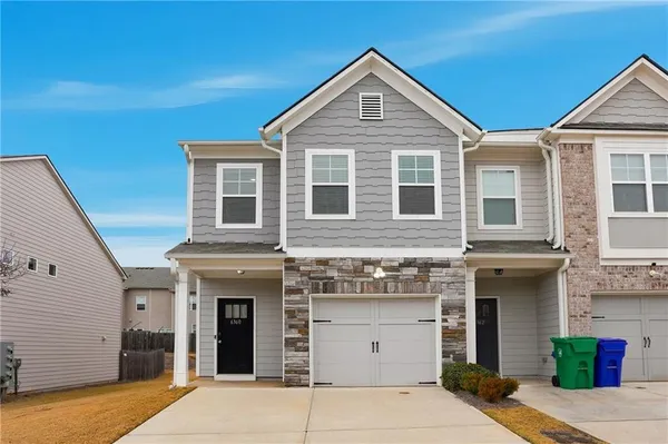 a front view of a house with a garage