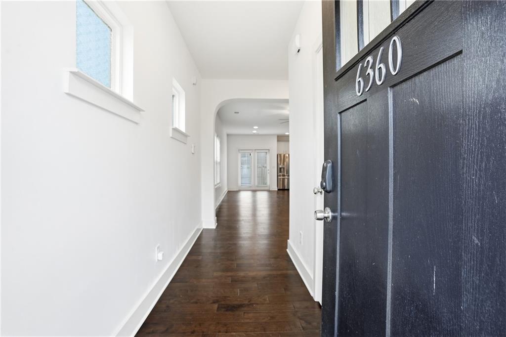 6360 Princeton Ridge Drive, Unit 6360 Lithonia, GA 30058 - Photo 3 of 16 a view of a hallway with wooden floor and staircase