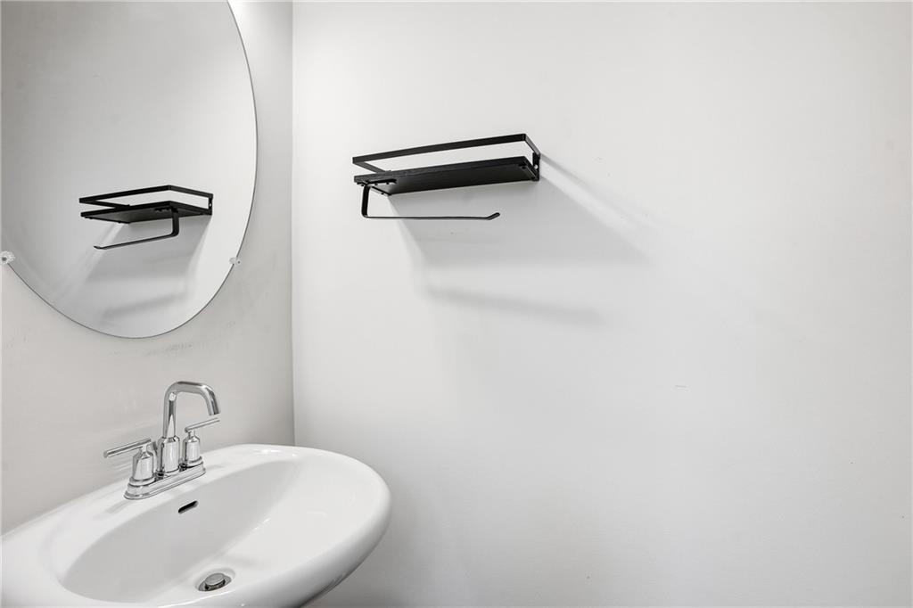 6360 Princeton Ridge Drive, Unit 6360 Lithonia, GA 30058 - Photo 7 of 16 a bathroom with a sink a toilet and mirror