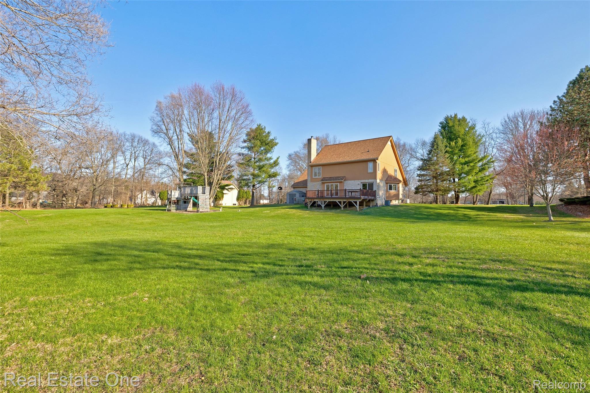 6400 Oakhill Road Ortonville, MI 48462 - Photo 65 of 82 View of green lawn featuring a deck