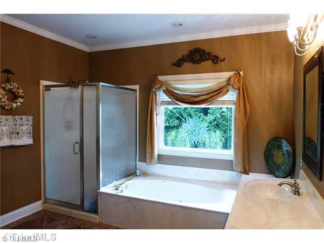 307 Georgetowne Drive Elon, NC 27244 - Photo 11 of 16 Master Bath/Spa. Master bath with large walk-in closet, jetted tub, separate shower, tile flooring, and double-sink vanity