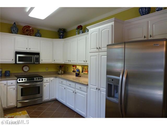 307 Georgetowne Drive Elon, NC 27244 - Photo 8 of 16 Kitchen. Chef s kitchen with cabinetry on 3 sides, Silestone counters, and stainless appliances