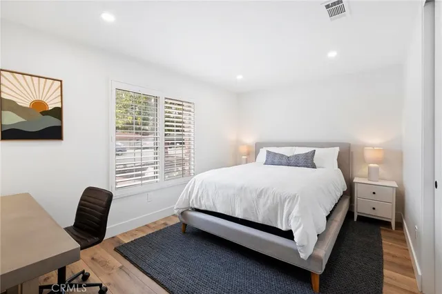 a bathroom with a double vanity sink toilet and a mirror