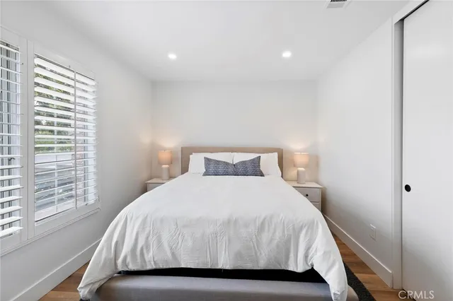 a bedroom with a bed and a night stand