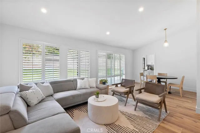 a kitchen with stainless steel appliances granite countertop a stove a sink and white cabinets