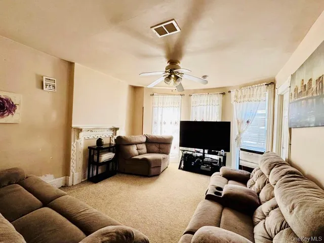 a living room with furniture flowerpot and a chandelier