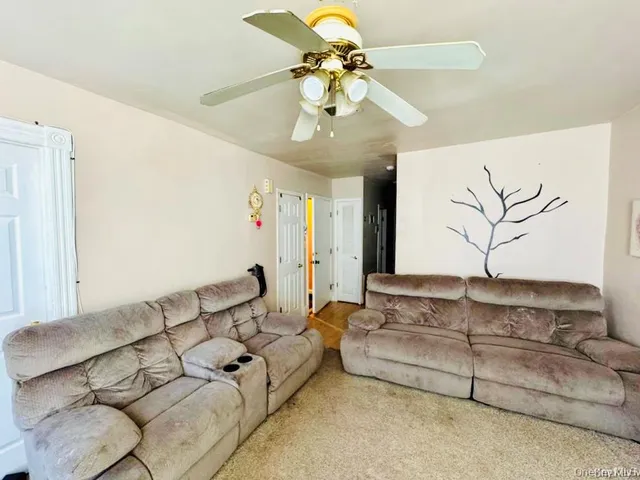 a bedroom with a bed and a flat tv screen on dresser