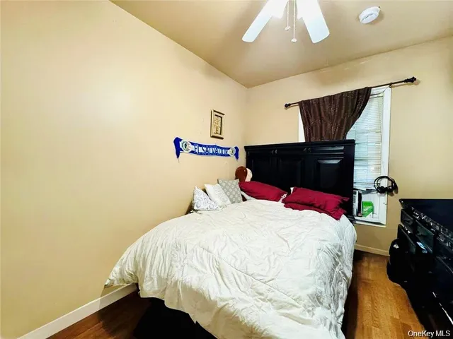 a kitchen with a refrigerator a stove a sink dishwasher a dining table and chairs with wooden floor