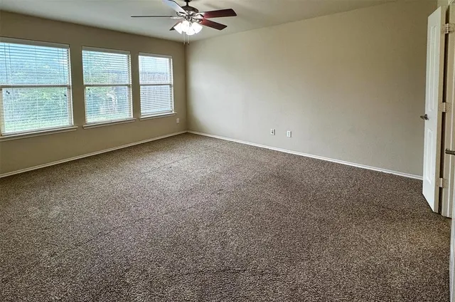 an empty room with a empty space and windows