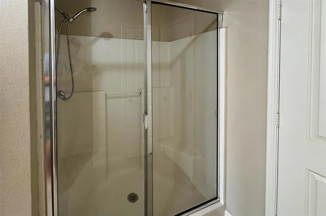 a bathroom with a glass shower door
