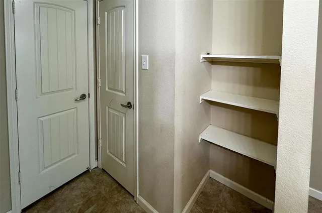 a view of room with walk in closet and bathroom