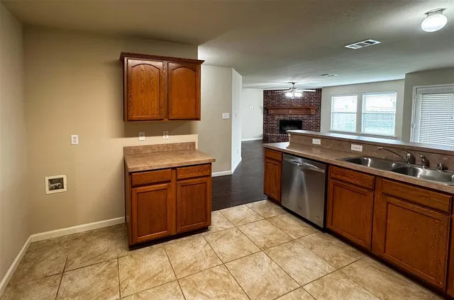 a kitchen with stainless steel appliances granite countertop a sink and a stove