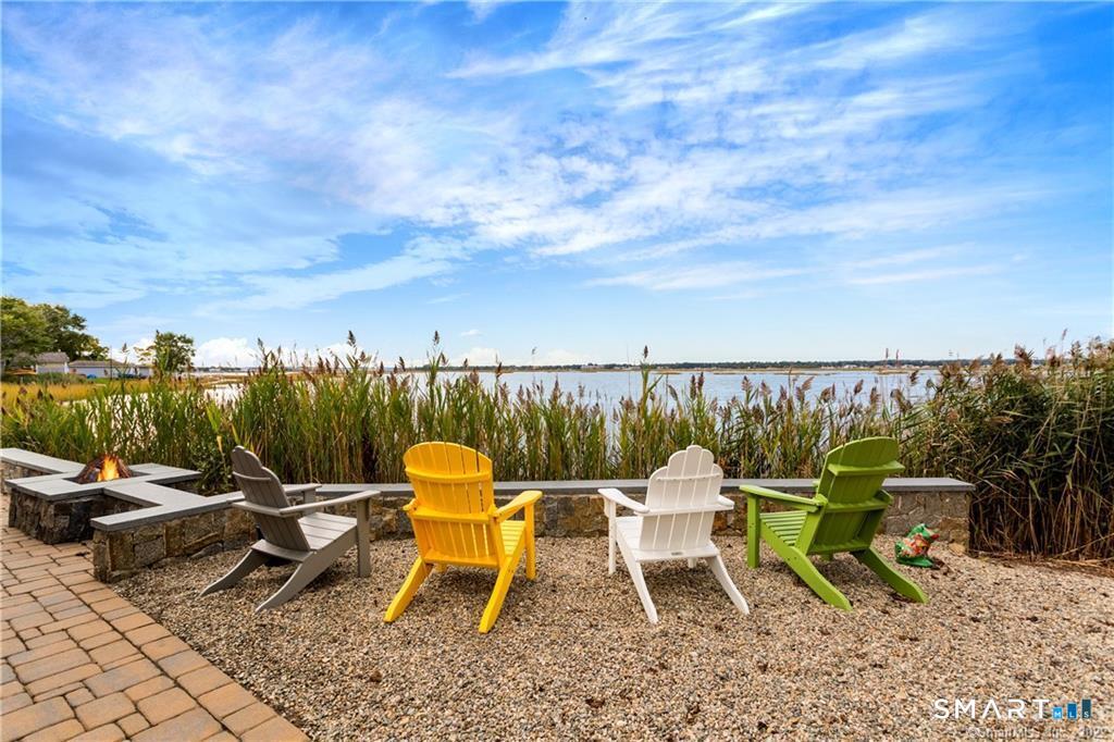 50 Milford Point Road Milford, CT 06460 - Photo 5 of 6 a view of a lake with a table and chairs