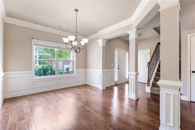 a view of a room with wooden floor fireplace and windows