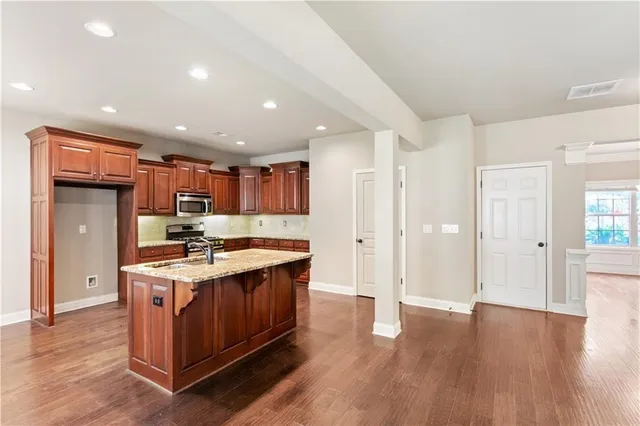 a kitchen with stainless steel appliances granite countertop a stove and a refrigerator