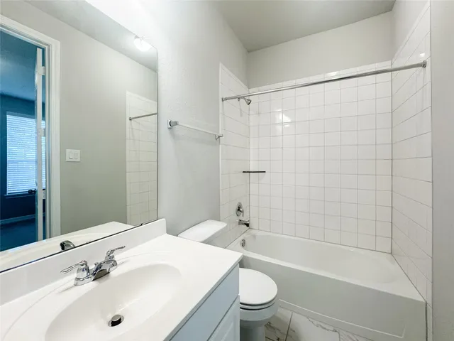 a bathroom with a sink mirror toilet and bathtub