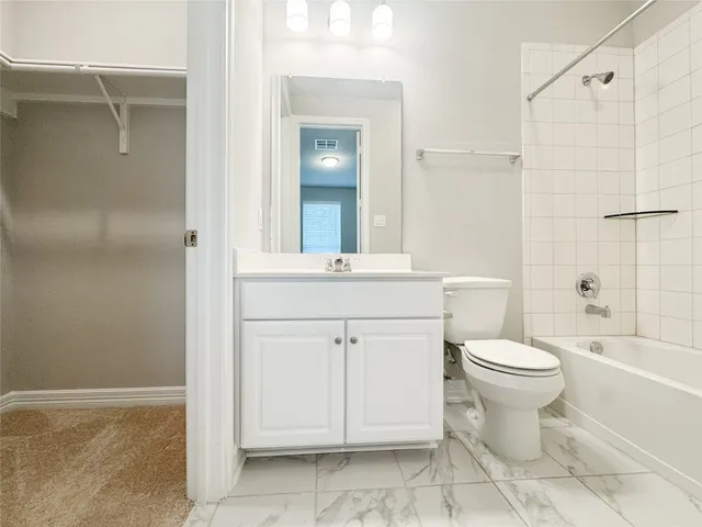 a bathroom with a toilet sink and shower