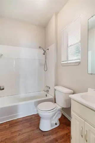 a white toilet sitting next to a bath tub shower