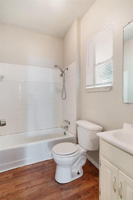 1358 Bonham Street Paris, TX 75460 - Photo 12 of 19 a white toilet sitting next to a bath tub shower