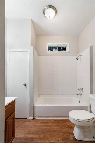 a bathroom with a bathtub and a toilet