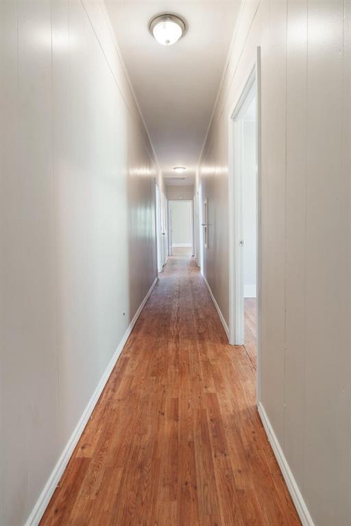 1358 Bonham Street Paris, TX 75460 - Photo 18 of 19 a view of a hallway with wooden floor