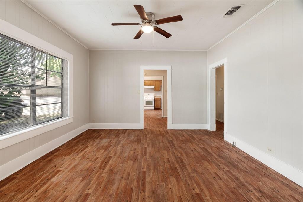 1358 Bonham Street Paris, TX 75460 - Photo 5 of 19 a view of empty room with wooden floor and fan