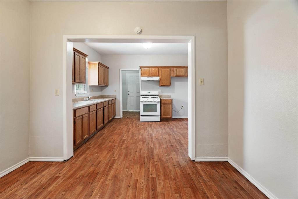 1358 Bonham Street Paris, TX 75460 - Photo 6 of 19 a view of kitchen with sink and wooden floor