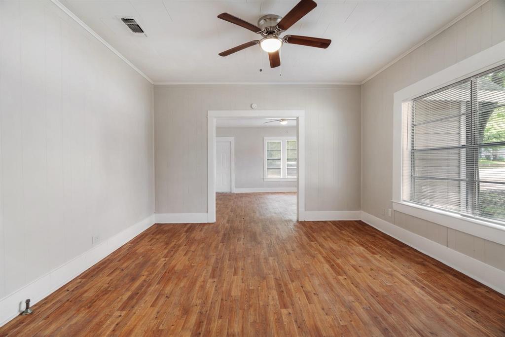 1358 Bonham Street Paris, TX 75460 - Photo 7 of 19 a view of empty room with wooden floor and fan