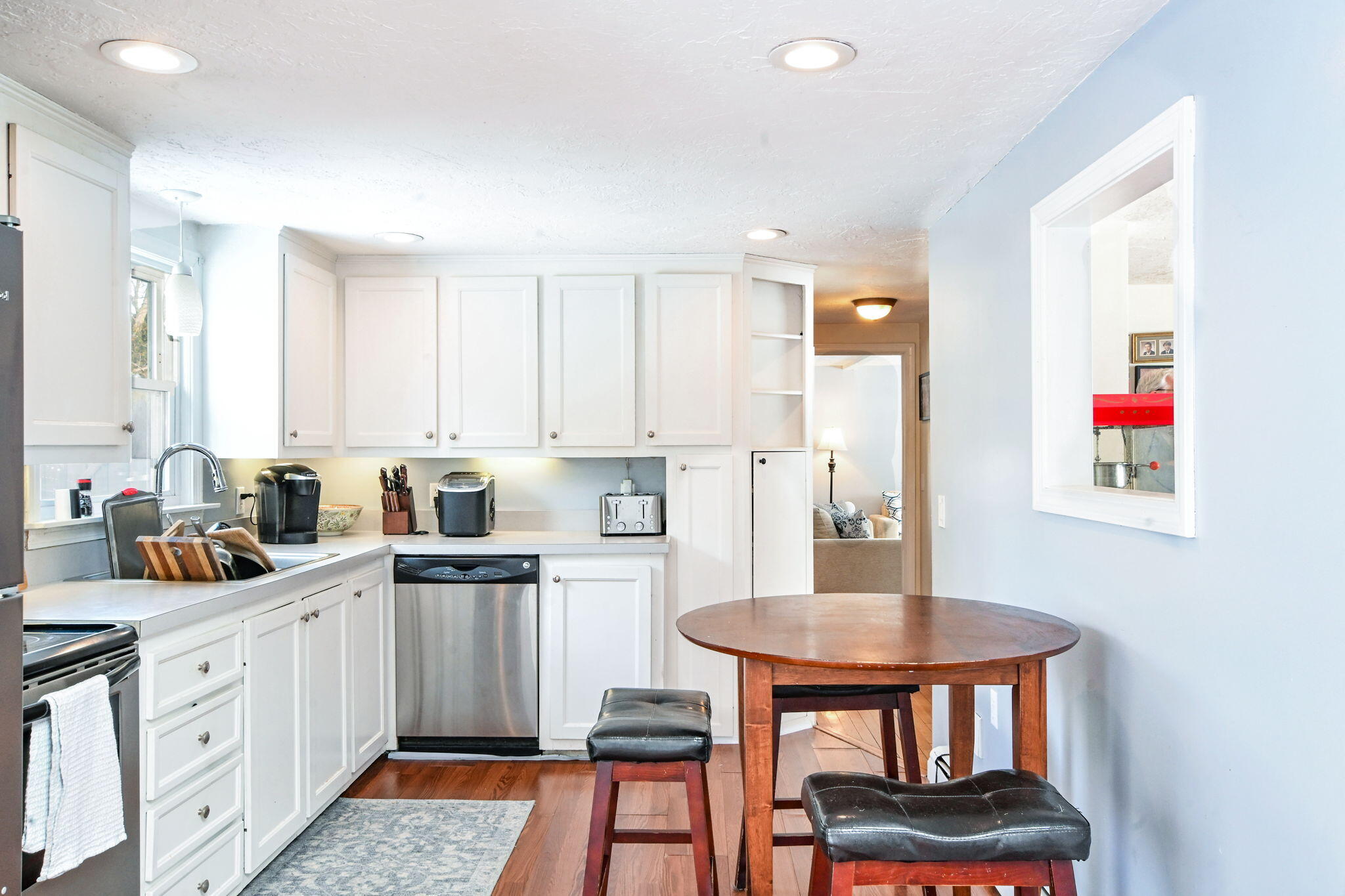 22 Winsome Road South Yarmouth, MA 02664 - Photo 7 of 30 a kitchen with stainless steel appliances granite countertop a stove a sink dishwasher and white cabinets with wooden floor