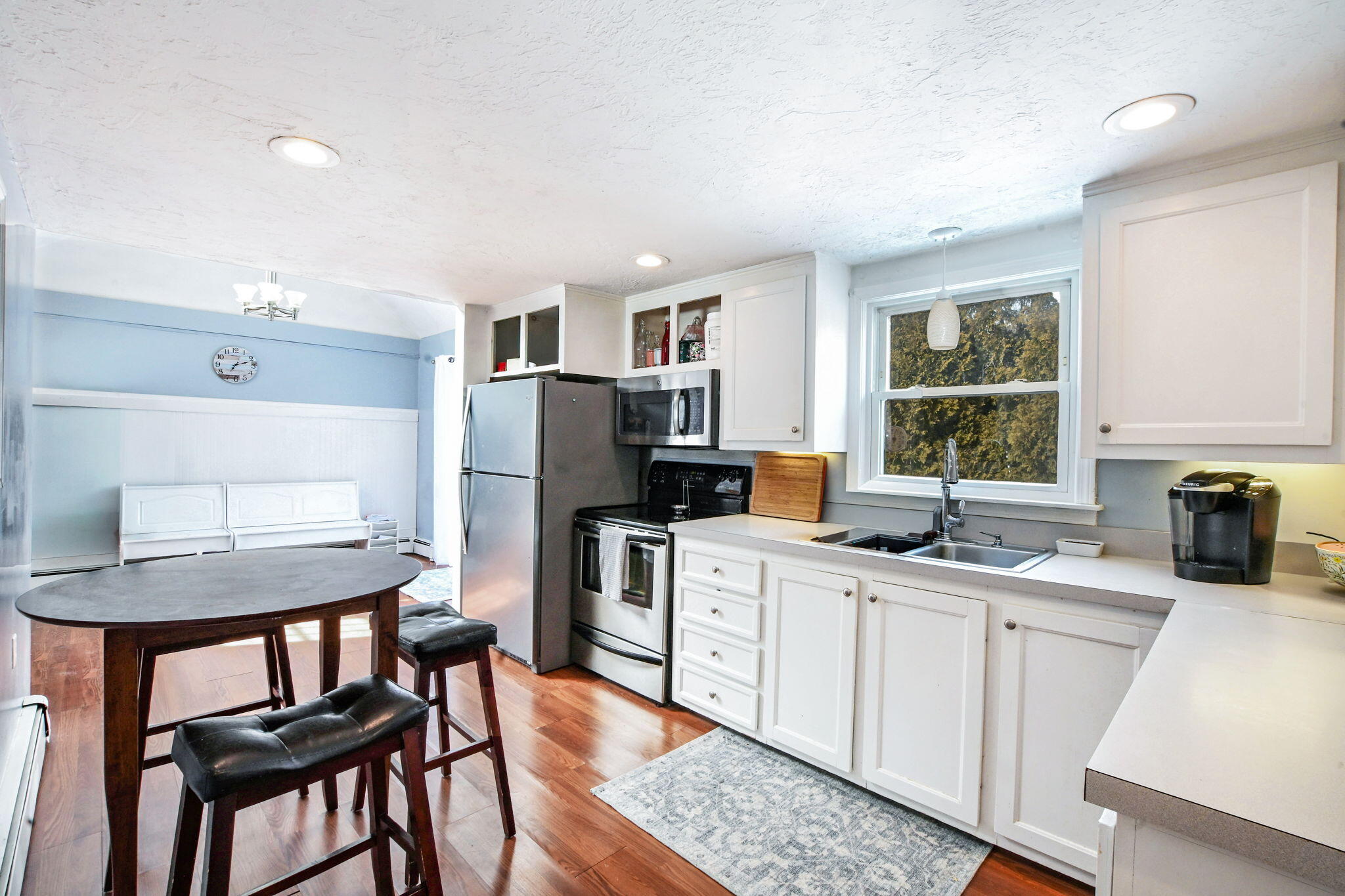 22 Winsome Road South Yarmouth, MA 02664 - Photo 8 of 30 a kitchen with a table chairs refrigerator and microwave