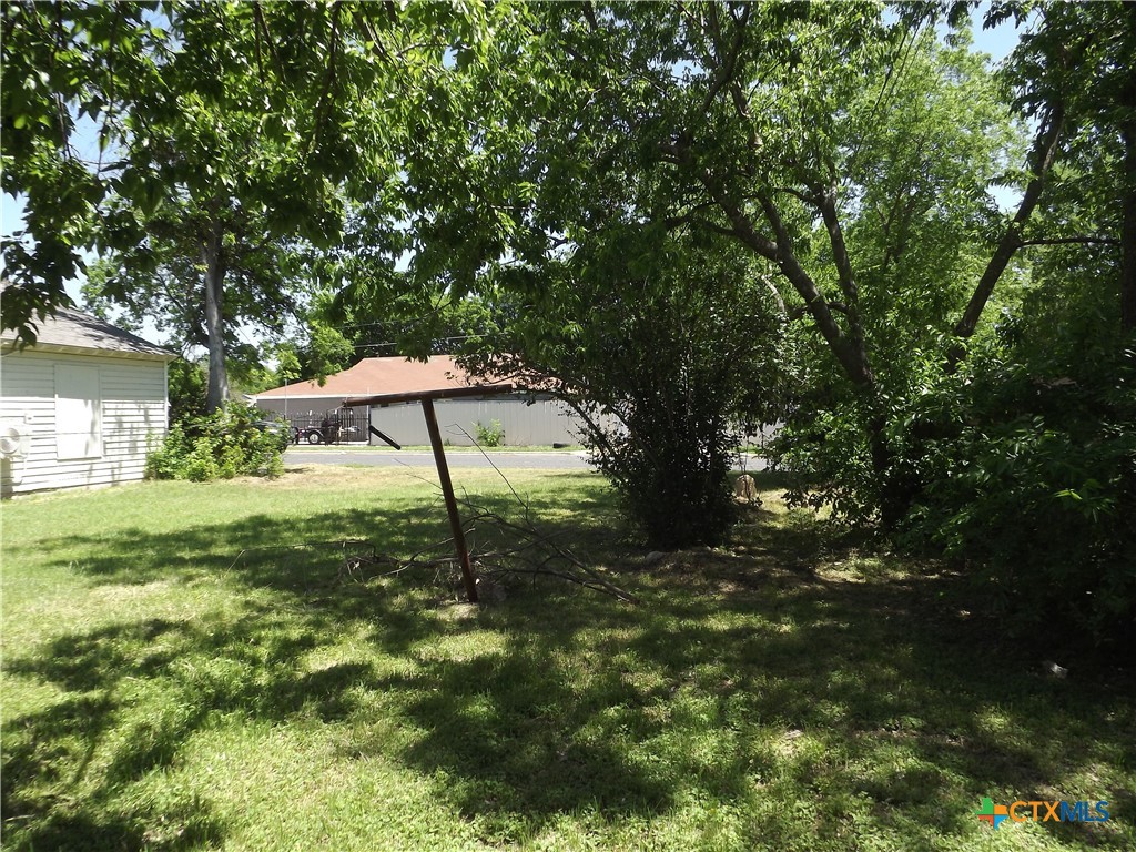 1714 Duncan Avenue Killeen, TX 76541 - Photo 18 of 24 a backyard of a house with table and chairs under an umbrella