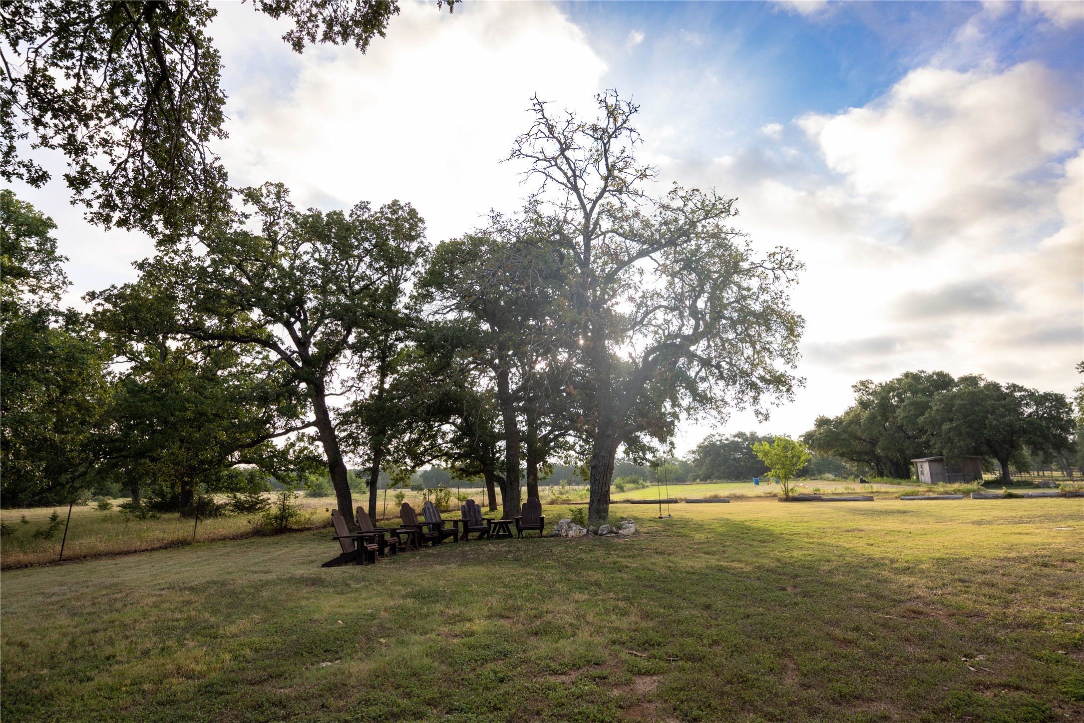 240 Lanier Ranch Road, Unit B Driftwood, TX 78619 - Photo 11 of 26 An expansive rural landscape offers natural shade and a tranquil setting for outdoor enjoyment.