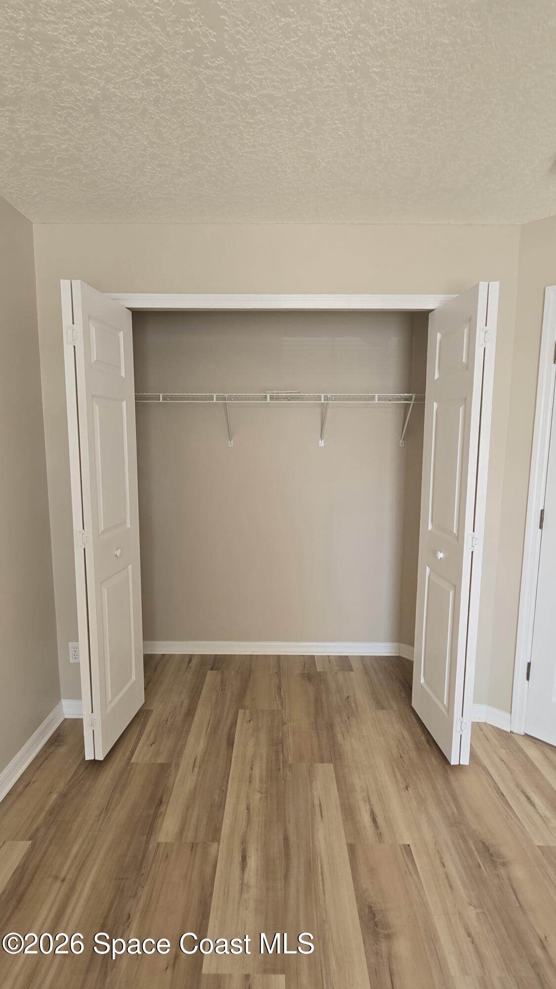 1977 Myrtle Court Palm Bay, FL 32905 - Photo 13 of 19 an empty room with wooden floor and closet