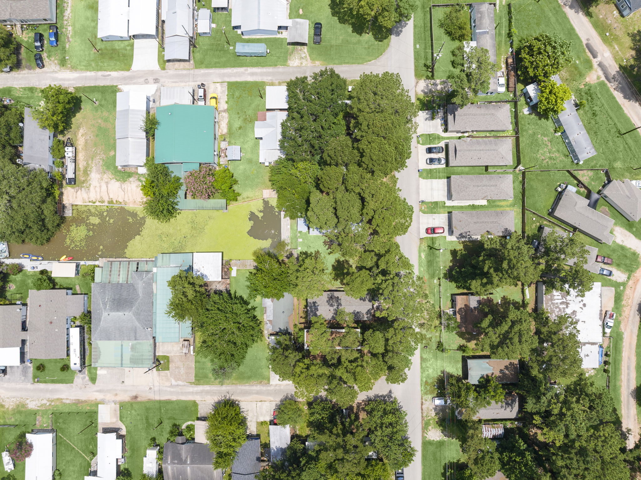 9649 Warm Spring Willis, TX 77318 - Photo 30 of 30 An aerial perspective reveals a residential community nestled among mature trees and a tranquil waterway.
