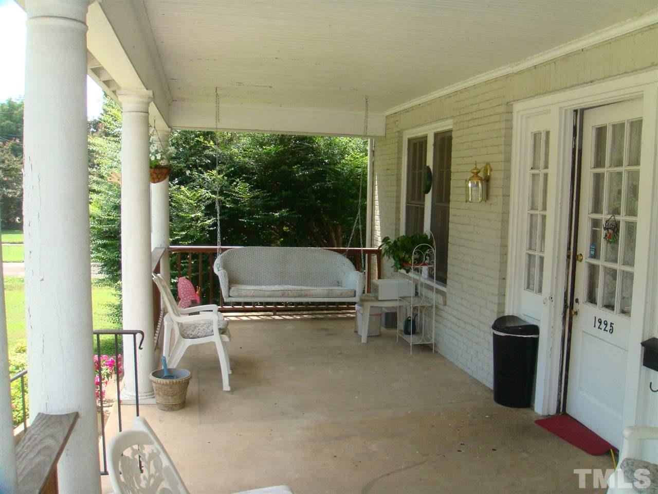 1225 Old Wake Forest Road Raleigh, NC 27604 - Photo 2 of 11 a living room with patio furniture and a potted plant