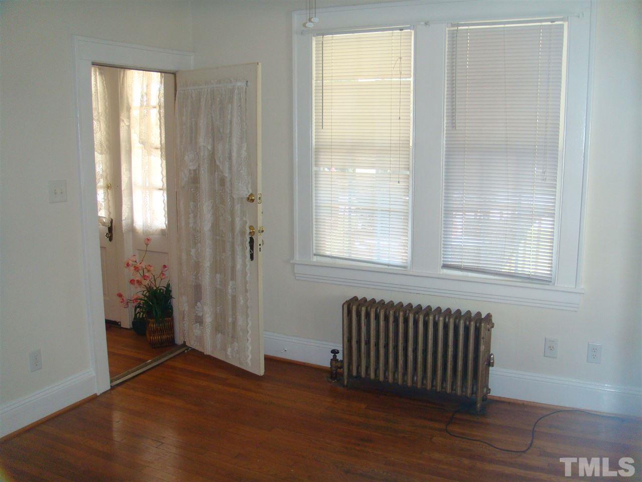 1225 Old Wake Forest Road Raleigh, NC 27604 - Photo 4 of 11 an empty room with wooden floor and windows