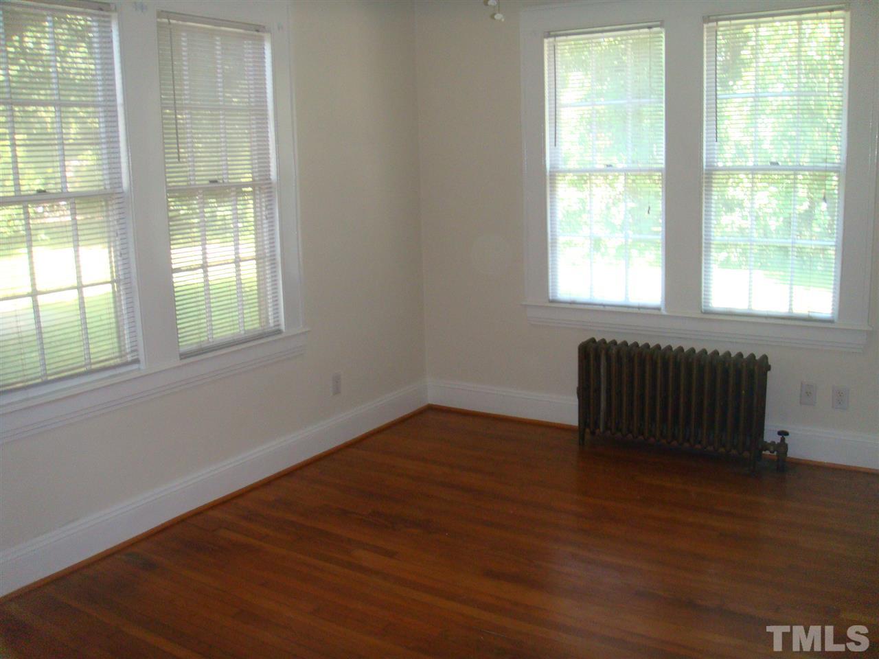 1225 Old Wake Forest Road Raleigh, NC 27604 - Photo 6 of 11 an empty room with wooden floor and windows