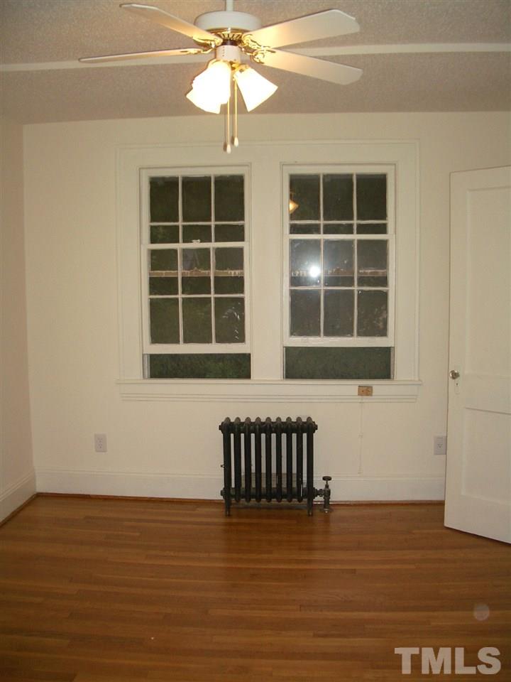 1225 Old Wake Forest Road Raleigh, NC 27604 - Photo 9 of 11 an empty room with wooden floor and windows