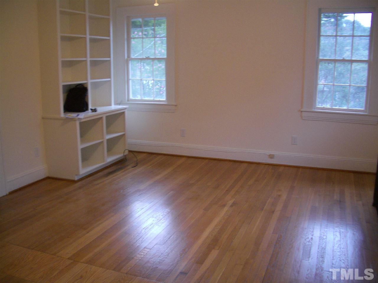 1225 Old Wake Forest Road Raleigh, NC 27604 - Photo 10 of 11 an empty room with wooden floor and windows