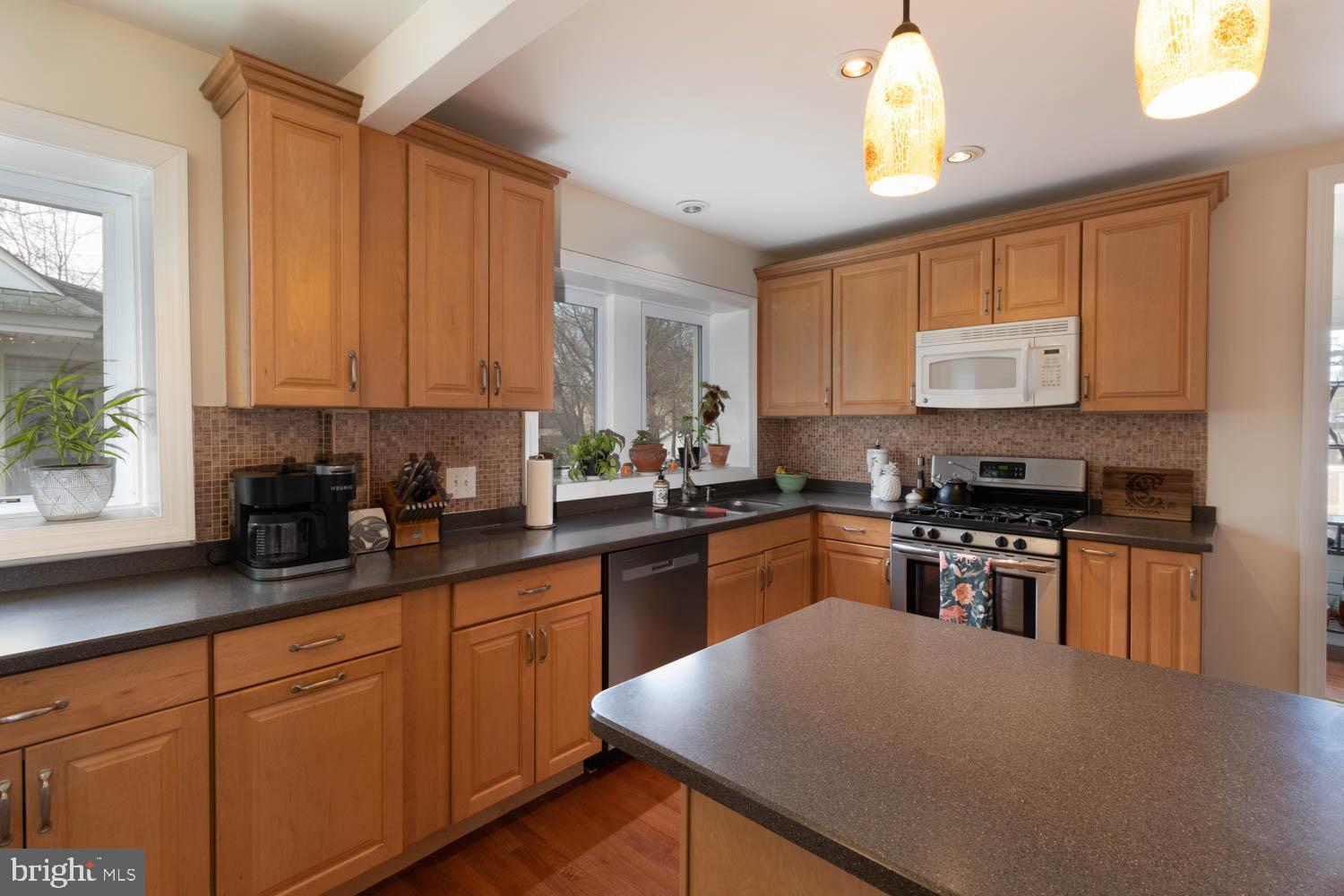 412 Oxford Road Havertown, PA 19083 - Photo 15 of 30 a kitchen with stainless steel appliances granite countertop a stove a sink a microwave and a refrigerator